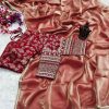 Close-up of red embroidered blouse and tissue saree texture