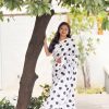 Elegant white satin saree with black polka dots on a model