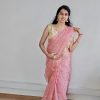 Woman wearing peach organza saree with golden butta – festive traditional wear